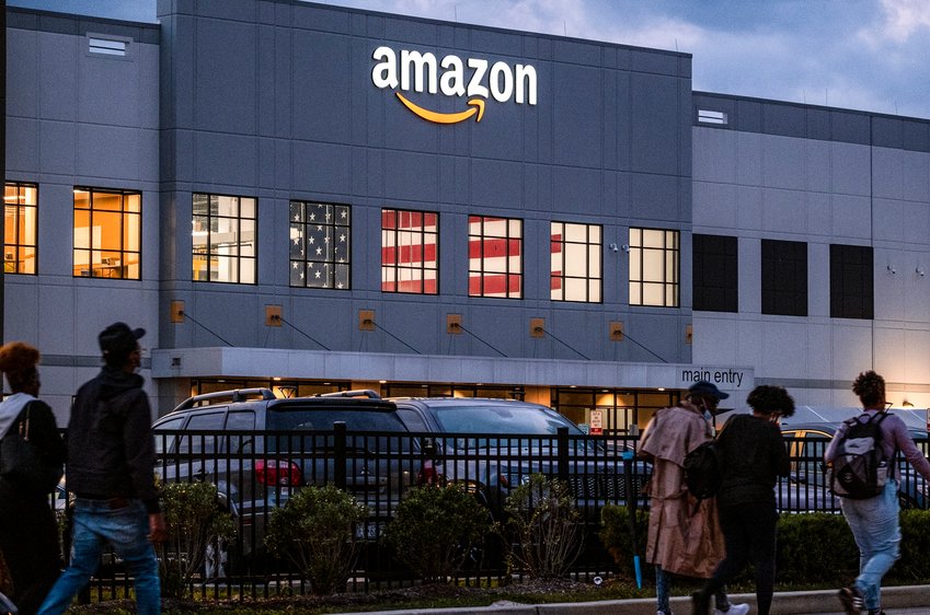 People arrive for work at the Amazon distribution center in the Staten Island borough of New York, Monday, Oct. 25, 2021.  The National Labor Relations Board approved a union election in April at a second Amazon warehouse in Staten Island.