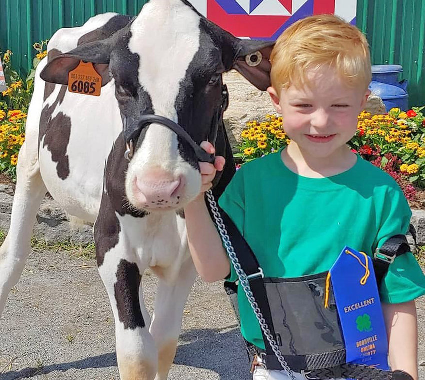 MEET ME! &mdash; A 4-H youth participant shows off his calf in this file photo. A host of friendly animals and Mother&rsquo;s Day crafts will be featured family fun on 4-H Clover Day, Saturday, May 7, at Runnings in Rome.