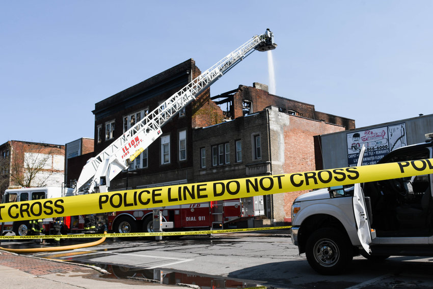 Crews douse an apartment building located at 236 N. Main Street in Herkimer with water on Thursday morning. The fire was called in on Wednesday night. No injuries were reported and the fire was confined to the third floor.