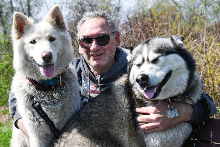 Lewis Carinci with his dogs Sophie, left, and Bello, right at the Phillip A Rayhill Memorial Trail in New Hartford. Sophie was allegedly beaten with a wrench on the New York State Thruway&rsquo;s Chittenango Rest Stop in March, but has since found a home with her foster family.