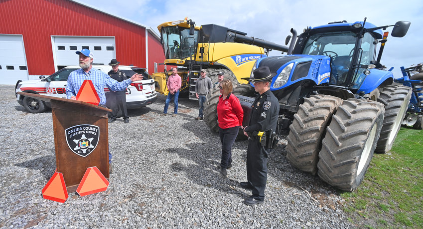 Steuben farmer Benjamin Simons discusses the use of SMV emblems and to alert motorist to SMV&rsquo;s during the plowing and planting season, during a recent event with Oneida County Sheriff Robert M. Maciol.  As summer approaches, farmers grow ever busier, and groups are urging state leaders to keep the overtime threshold for family farms to 60 hours.