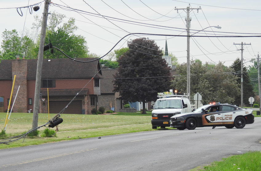 Rome Police control the scene after a passing tractor trailer pulled down utility wires on Cypress Street shortly before 10 a.m. on Monday. Authorities said the nearby Rome Catholic High School was temporarily without power. National Grid responded to the scene to fix the downed wires.