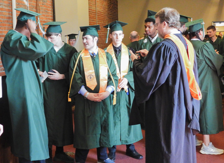 Mohawk Valley Community College graduates get ready to walk as commencement ceremonies are about to begin at the Stanley Theater, 259 Genesee St., Utica, on Friday.