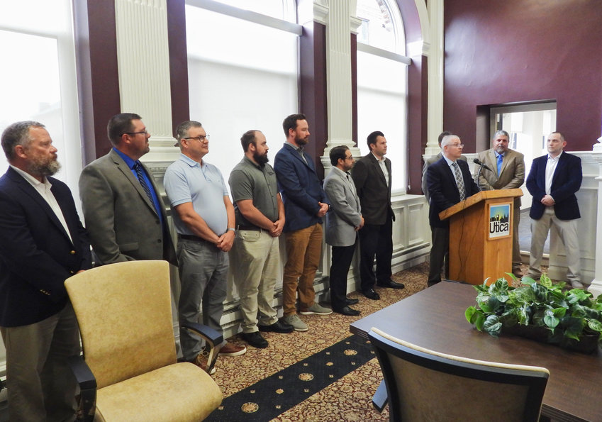 Barton &amp; Loguidice President and CEO John Brusa explains the move to Utica and all its benefits to both current and future employees of the multi-disciplinary consulting firm. Pictured are a number of B &amp; L employees, many of whom are Utica locals.