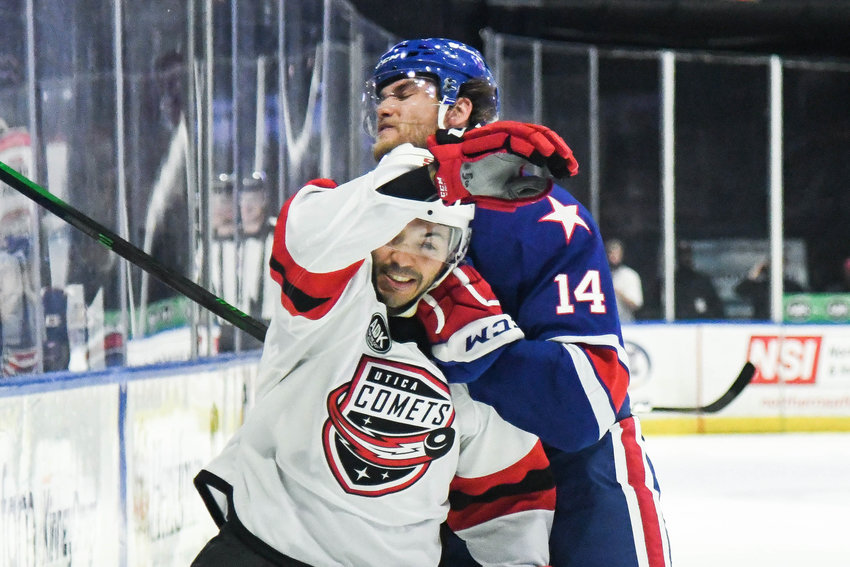 Utica Comets defenseman Robbie Russo is grabbed by Rochester&rsquo;s Mark Jankowski during Game 2 of the North Division semifinals on Saturday in Utica. Russo, a veteran defenseman, was suspended Tuesday before Game 4 of the series for what the AHL said was an illegal check to the head to Rochester&rsquo;s Michael Mersch on Sunday. He did not play Tuesday.