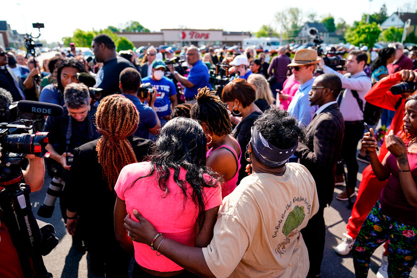 People gather outside the scene of a shooting at a supermarket, in Buffalo, N.Y. The NAACP, the nation&rsquo;s oldest civil rights organization, said it will propose a sweeping plan meant to protect Black Americans from white supremacist violence, in response to a hate-fueled massacre that killed 10 Black people in Buffalo.