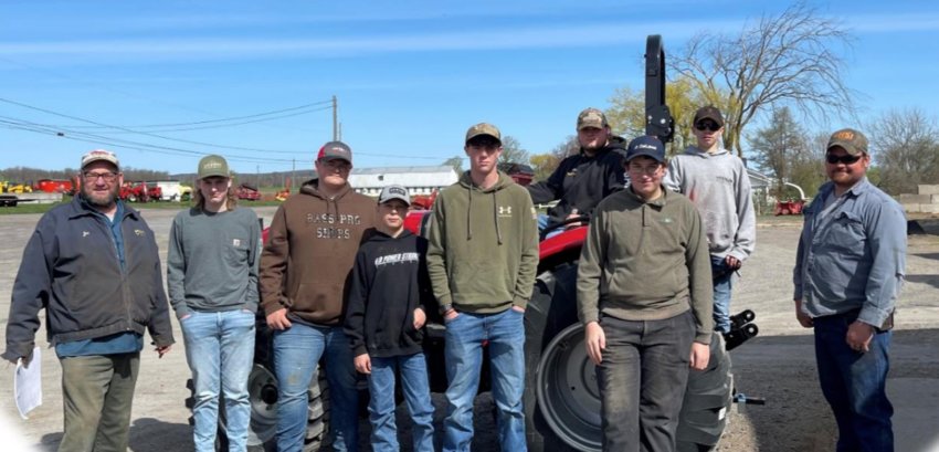 A group of youngsters recently completed a tractor safety course. From left: Instructor Joe Bush, and students: Darrian Brown, Hunter Zawisza, Dawson Jones, Nolan Brownell, Nathan Virkler and Amos Bush. Seated on the tractor is Jacob Davis and standing on tractor Dakota Maciejko.