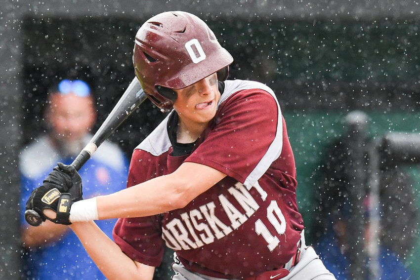 Oriskany's Ty Zizzi swings at a pitch in the rain during the Section III Class D semifinal against Brookfield on Saturday at Donovan Stadium at Murnane Field in Utica. Oriskany won 8-1 to advance to the Class D title game on Tuesday.