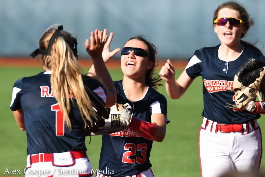 New Hartford player Olivia Vitullo (23) celebrates with teammate Taylor Raux (1) after making a play in the outfield during the Section III Class A final against Auburn on Thursday at Onondaga Community College.