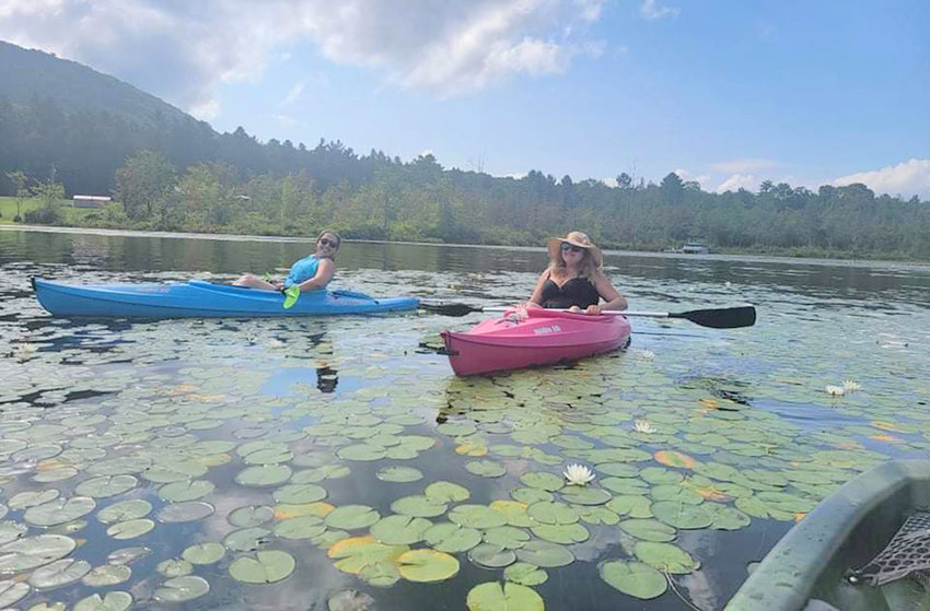 From left, Megan Plete Postol and Lindsay Maida kayaking in the Southern Adirondacks.