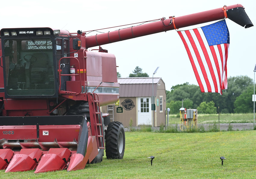 SHOWING PRIDE &mdash; An American flag is hung from a combine at Wagner Farms, 5841 Old Oneida Road, Rome, earlier this week.  The spring weather has been favorable for a host of different crops at the local agribusiness, with corn, potatoes and other vegetables thriving, according to Wagner Farm&rsquo;s Facebook page.