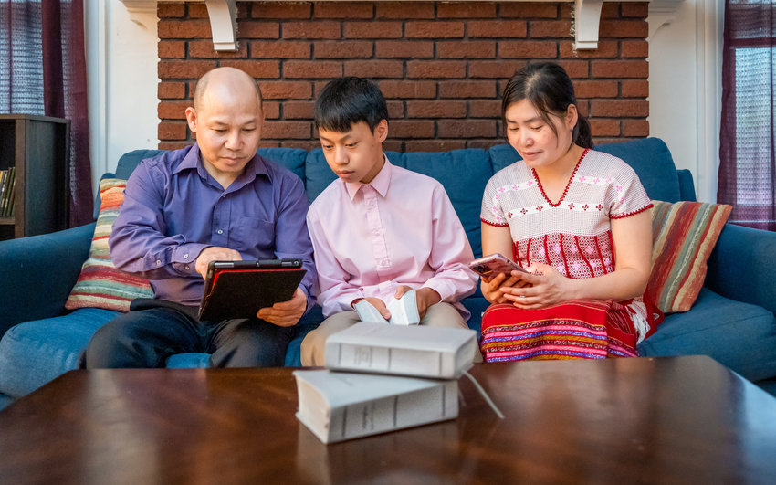 Ku Law and Hla Htoo, of Utica, read the Bible with their 13-year-old son in their native language, S&rsquo;gaw Karen, on jw.org.