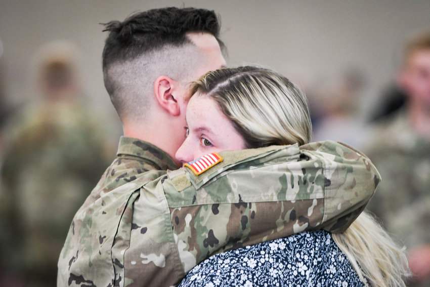Austin Butler hugs his wife, Laina, following a farewell ceremony for soldiers of the 2nd Battalion, 108th Infantry of the New York Army National Guard on Tuesday morning at Mohawk Valley Community College in Utica.