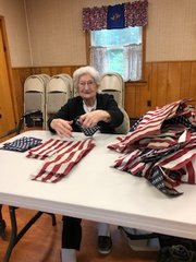 FLAG RETIREMENT &mdash; The Holland Patent Chapter of the National Society of the Daughters of the American Revolution hosted a flag retirement ceremony on Saturday at the Leon H. Roberts American Legion Post 161.  Above, Anne Edwards, a HPDAR member and past chapter regent, prepares flags for the ceremony. Also helping to prepare the flags for retirement and joining in the ceremony were Children of the American Revolution, NYDAR District V Director Mary Cardinale, Fort Stanwix DAR Chapter Regent Erin Gurdak, Astenrogen DAR Chapter Regent-Elect Naomi Starsiak, and Skenandoah DAR Chapter Regent Sue Bowley, as well as members of Roberts Post, the Roberts Post Auxiliary, and community members.  More than 1,000 flags were retired.