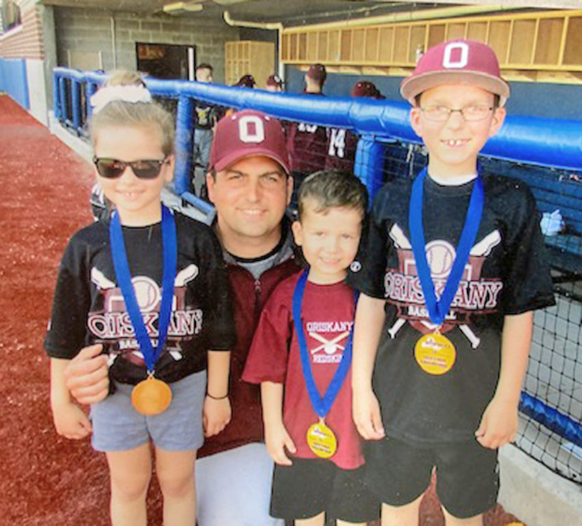 Oriskany baseball head coach Tom Meiss poses with his three children after the team&rsquo;s Section III Class D title game win over Poland in 2018. With him are, from left: daughter Alyssa and sons Andrew and Caden.