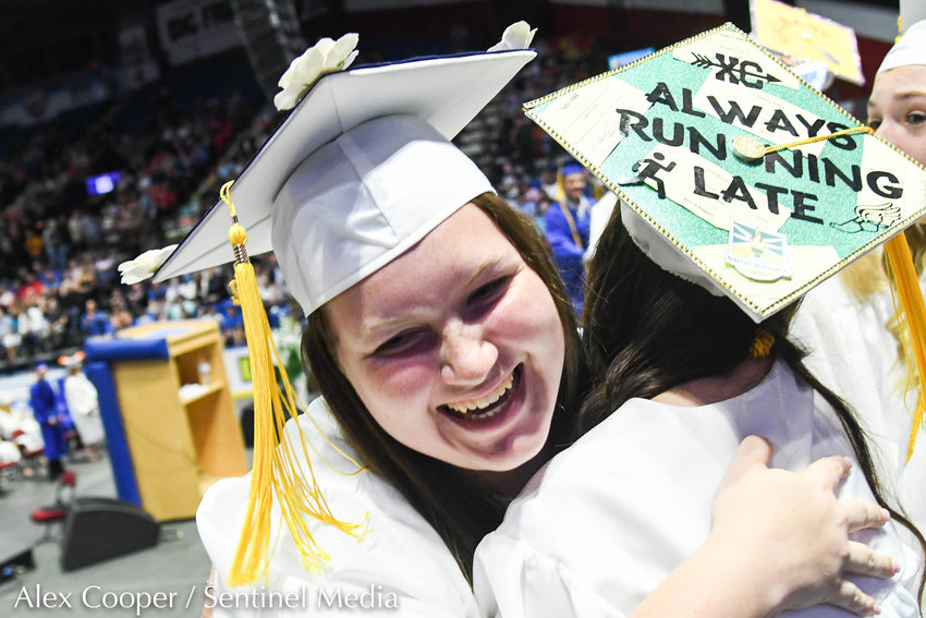 Megan Brinck hugs a fellow graduate after receiving her diploma during Whitesboro High School's 87th annual commencement ceremony for the class of 2022 on Saturday at the Adirondack Bank Center at the Utica Memorial Auditorium.