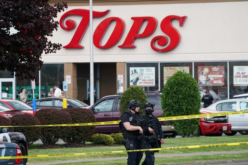 FILE - Police secure an area around a supermarket where several people were killed in a shooting, Saturday, May 14, 2022, in Buffalo, N.Y.  New York&rsquo;s new law barring sales of bullet-resistant vests to most civilians doesn't cover the type of armor worn by the gunman who killed 10 people at the Buffalo supermarket, a gap that could limit its effectiveness in deterring future military-style assaults.