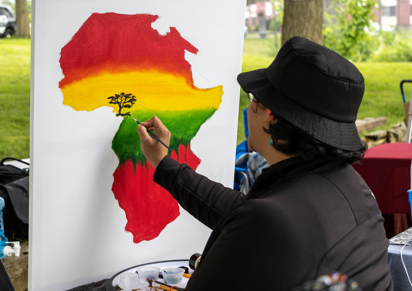 JUNETEENTH CELEBRATION &mdash; Monique Livingston of Utica, creates a painting at the Juneteenth Celebration in Utica, on Saturday, June 18. The federal holiday &mdash; which commemorates the emancipation of enslaved African Americans &mdash; was officially observed on Monday along with a host of events throughout the weekend, including celebrations in Utica and Rome.