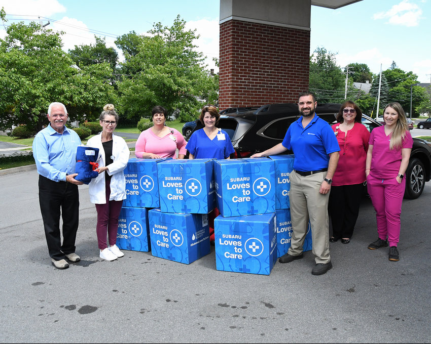 Carbone Subaru of Utica and its partners donate blankets and messages of hope to patients fighting cancer at the Cancer Center at Mohawk Valley Health System. From left: Chris Cardello, sales manager at Carbone Subaru; Carly Insel, chief radiation therapist; Christie Kozyra, oncology information management; Becky Dean, radiation oncology; Steven DeGrace, finance manager at Carbone Subaru; Jennifer Humphrey, administrative assistant; and Dr. Brittany Simone, radiation oncologist at MVHS Cancer Center.