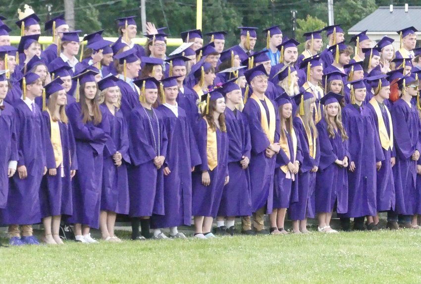 Students in their caps and gowns await to receive their diplomas in Holland Patent during the school district&rsquo;s 143rd Commencement Ceremony on Friday night at the high school athletic complex.