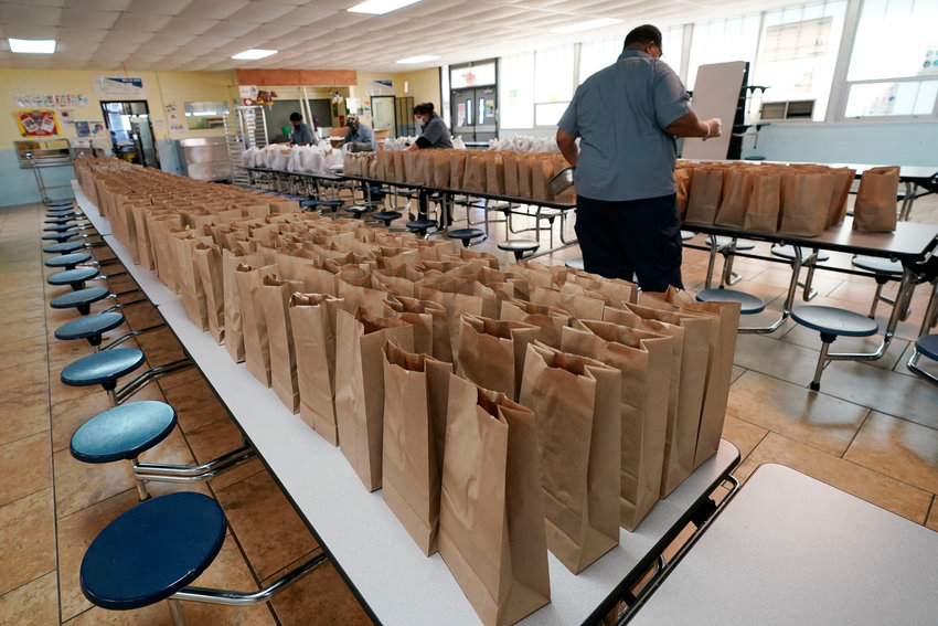 In this Associated Press file photo, Jefferson County School District Food Service Department staff arrange some of the hundreds of free lunches that will be given to students, March 3, 2021 in Fayette, Miss. As one of the most food insecure counties in the United States, many families and their children come to depend on the free meals as their only means of daily sustenance.