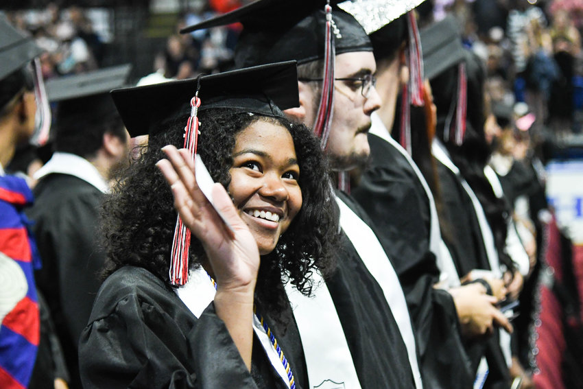 Graduate Ruby Brice waves to the crowd during the annual commencement ceremony for Thomas R. Proctor High School on Friday at the Adirondack Bank Center at the Utica Memorial Auditorium.
