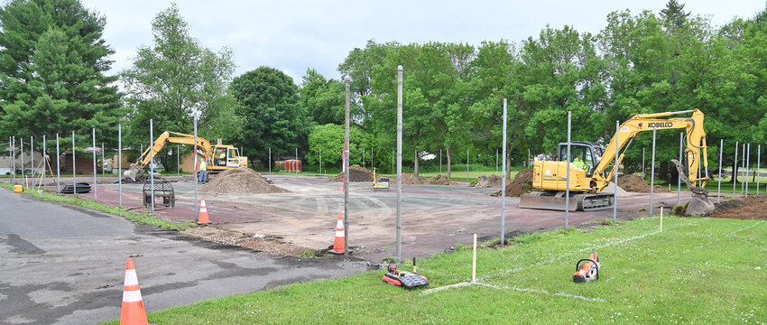 IN THEIR COURT NOW &mdash; Construction workers excavate the area around the outside of the tennis courts in the Lee Town Park on Thursday. The courts are being completely renovated as part of the town&rsquo;s 2022 capital project.