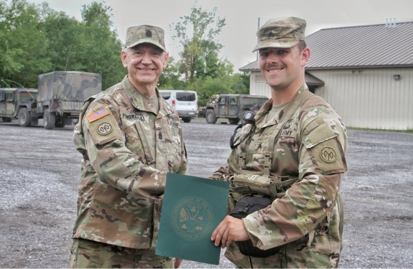 Command Sgt. Maj. David Piwowarski presents a certificate of achievement to Sgt. Ethan Hart, of Whitesboro, a combat medic assigned to Headquarters and Headquarters Company, 2nd Battalion, 108th Infantry Regiment for his participation in the U.S. Army best medic competition.