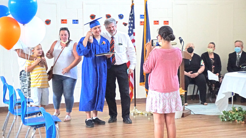 Students pose with family and staff during graduation ceremonies for the Tradewinds Education Center program.