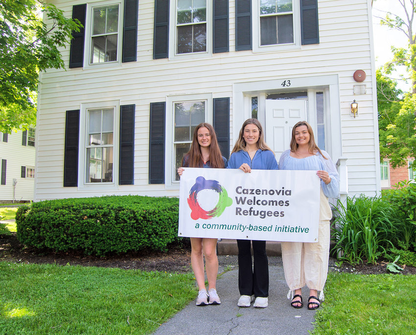Erin Kuhn, Quinlan Emhoff, and Amanda Pressly stand in front of the newly renovated home at 43 Lincklaen Street that will soon welcome a family from Afghanistan.(Photo submitted)