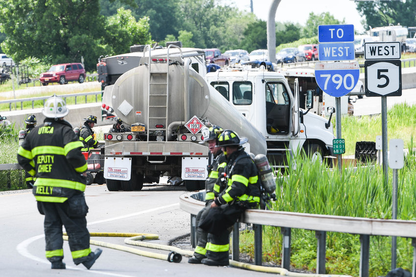 Utica firefighters take turns working to stop thousands of gallons of diesel fuel leaking out of this disabled tanker truck at the Route 790 on-ramp from Leland Avenue in north Utica early Thursday afternoon. All streets, roads, highways and businesses in the area were shut down in the area.