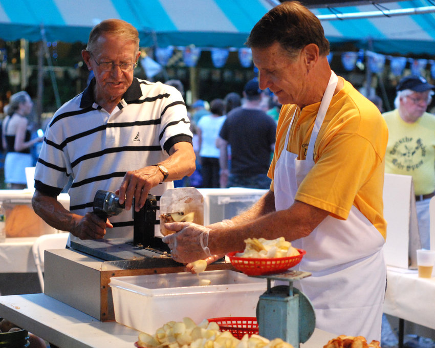 Jerrys Stys of Utica and Dr. Bill Kritzler of Marcy spin potatoes into ribbons to fry at the Bavarian Festival, in this 2011 file photo. This year, the Utica Maennerchor will once again present its annual Bavarian Festival Friday through Sunday, July 15-17, at 5535 Flanagan Road.
