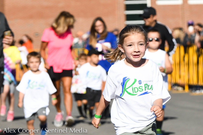 A young girl sprints toward the finish line during the Utica National Kids Run at Mohawk Valley Community College in Utica on Saturday.