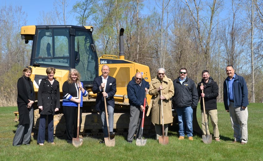 Local and company officials get ready to turn a shovelful of dirt to break ground on a 10,000 square foot expansion at The Light Connection, 132 Base Road in Oriskany. The expansion, which is expected to be completed in September, will increase the company&rsquo;s manufacturing footprint by 25%. From left:  Kim Teesdale; Susan Grabinski; Tricia Kowalski; Garry White, TLC president; Shawki Elgarhi; Murray Krishtein; Tyler Tormey; Lee Copperwheat; and Rob Pike.