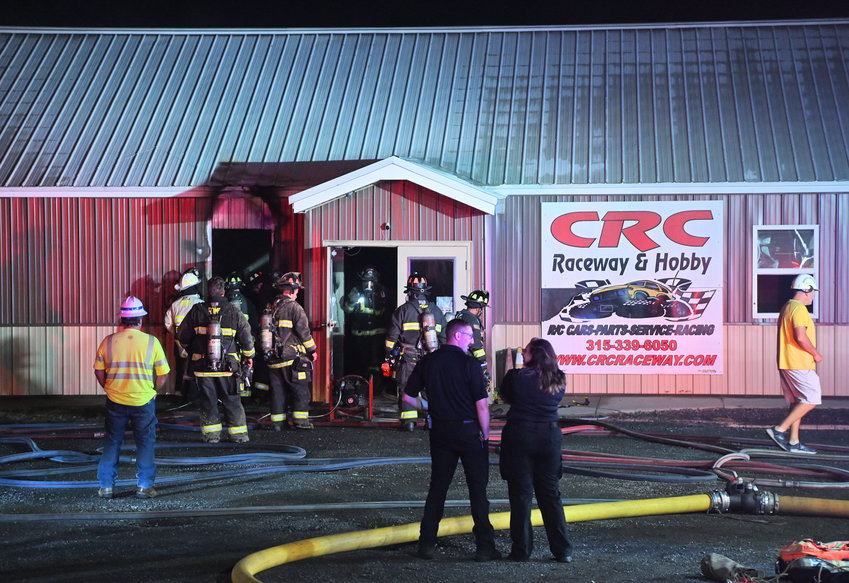 Rome firefighters knock down a fire at CRC Raceway &amp; Hobby on Martin Street Wednesday night. The cause of the fire remains under investigation. Company officials said racing will be temporarily suspended until they can reopen.