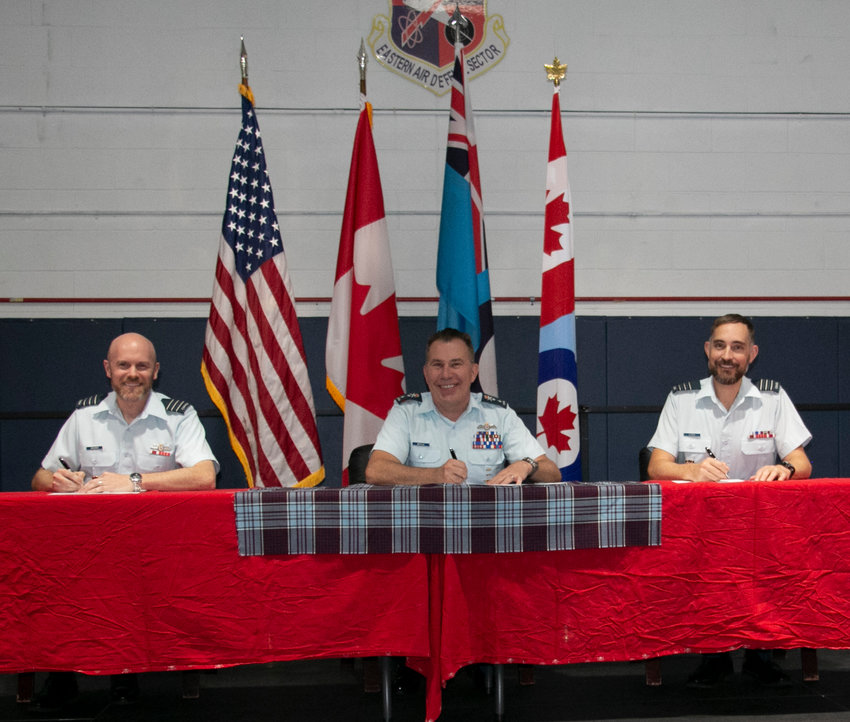 The Eastern Air Defense Sector&rsquo;s Canadian Detachment held a change-of-command Thursday afternoon at the Air Force Research Laboratory&rsquo;s fitness center gymnasium. Lt. Col. Michael Wiseman, left, assumed command from Lt. Col. Josh Klemen, right, during a signing ceremony, which is a long-standing tradition in the Canadian military. Royal Canadian Air Force Maj. Gen. Sean T. Boyle, the deputy commander, Continental U.S. NORAD Region (CONR) is seated in the center and was the ceremony&rsquo;s presiding officer.