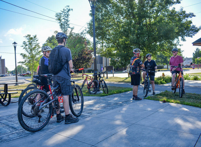 Bikers gather at the Oneida Rail Trail Pedestrian Plaza on Tuesday, July 12, 2022. Some are joining &quot;Tuesday on the Towpath,&quot; a historic tour of the Oneida Rail Trail and Erie Canalway Trail. Others are part of a mountain biking group about to embark on their own trek.