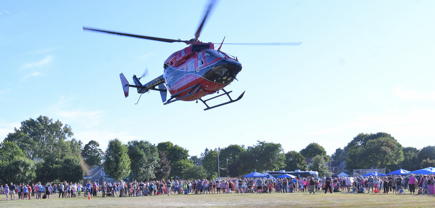 A big crowd watches Mercy Flight leave a past Law Enforcement Day at Franklyn&rsquo;s Field.