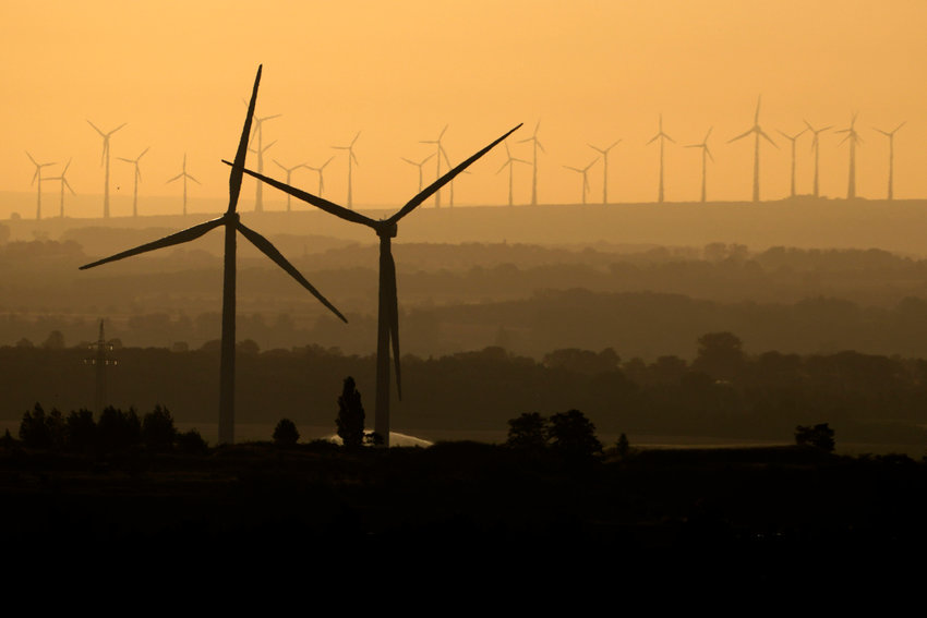 Wind turbines sit on a hill early Sunday morning, July 17, near Bad Harzburg, Germany. More than a century after it was founded with the wealth generated from the oil industry, the Rockefeller Foundation announced Tuesday, that it is making the fight against climate change central to all of its work, including its operations and investments.   (AP Photo/Matthias Schrader, File)