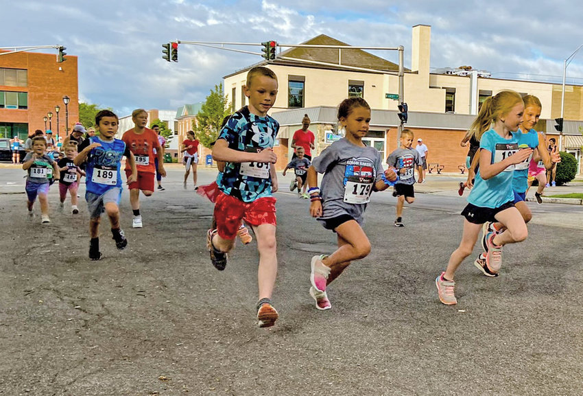 Participants in the Honor America Days Kids Fun Run race along the course in Rome Saturday. The race was held for the 50th time, making it the oldest of its kind in Central New York, according to the Roman Runners club.