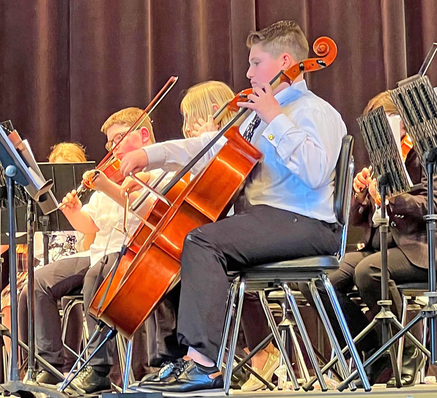 Jimmy Cooper, 13, who will enter Strough Middle School in Rome in the fall, plays his beloved cello during a school orchestra concert.