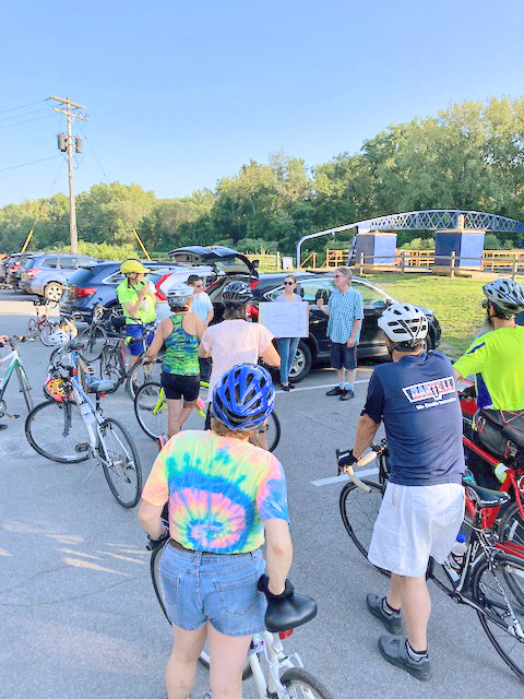 Riders listen to a presentation while on a ride on the Empire State Trail. Area residents and visitors are invited to experience local Erie Canal history by bike, then enjoy a pint of beer as part of a local entry in a statewide summer series along New York&rsquo;s canals.