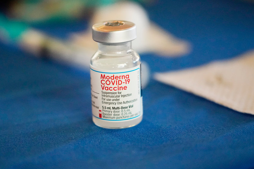 A vial of Moderna COVID-19 vaccine rests on a table at an inoculation station next to Jackson State University in Jackson, Miss., on July 19, 2022. British health authorities have authorized an updated version of Moderna's coronavirus vaccine that aims to protect against the original virus and the omicron variant.