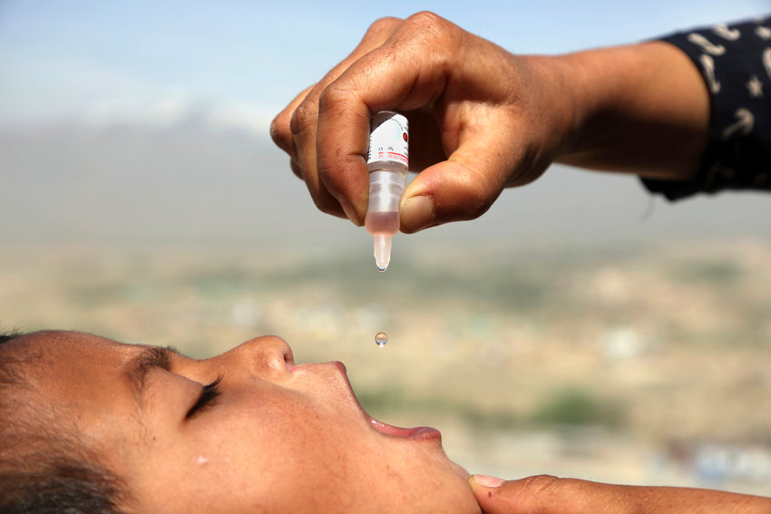 An Afghan health worker uses an oral polio vaccine on a child as part of a campaign to eliminate polio, on the outskirts of Kabul, Afghanistan, April 18, 2017. For years, global health officials have used billions of drops of an oral vaccine in a remarkably effective campaign aimed at wiping out polio in its last remaining strongholds &mdash; typically, poor, politically unstable corners of the world. Now, in a surprising twist in the decades-long effort to eradicate the virus, authorities in Jerusalem, New York and London have discovered evidence that polio is spreading there. The source of the virus? The oral vaccine itself.