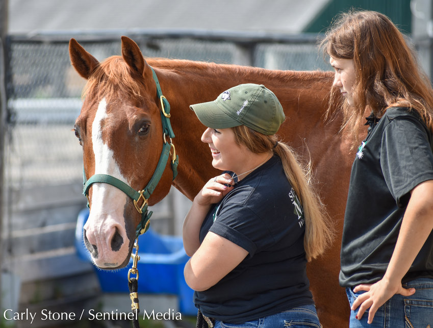 Megan Holloway (left) is a senior at SUNY Morrisville showing off Curly the 21-year-old American Quarter Horse at the World of Horses exhibit at the NYS Fair. She and Maggie Herbert, a junior, are studying Equine Science at the school to obtain a four-year degree.