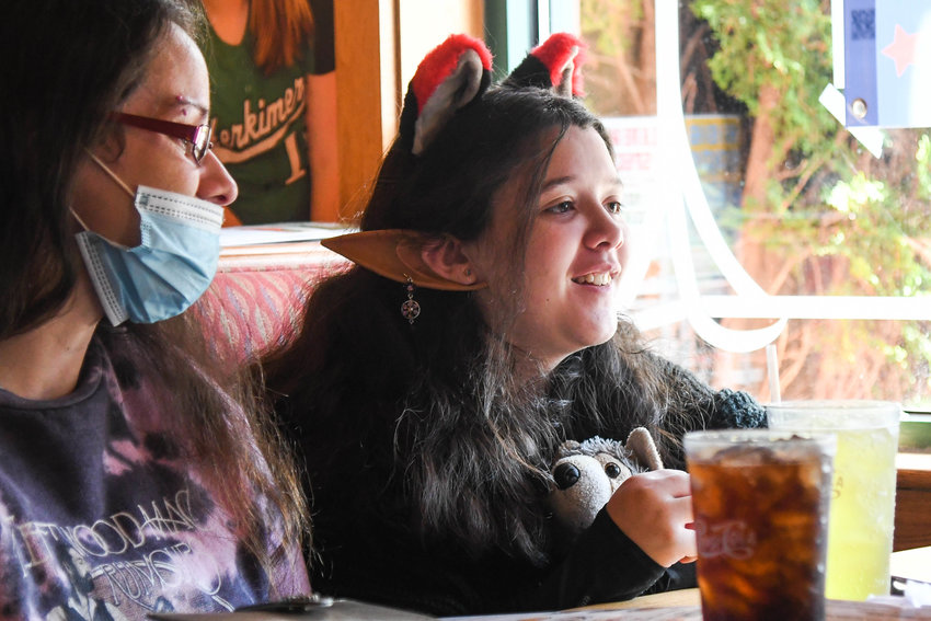 Twelve-year-old Serenity from Dolgeville holds a wolf stuffed animal and wears ears while receiving a wish from Make-A-Wish Central New York and Excellus BlueCross BlueShield on Wednesday at Applebee&rsquo;s in Herkimer. Her favorite animals are wolves and her wish will allow her to go camping with them in a safe environment at a wolf conservation center in South Salem, Massachusetts.