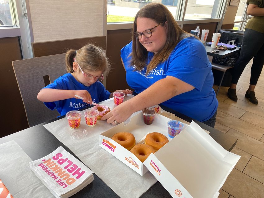 Mohawk Valley Wish Kid Raelyn Gordon, left, celebrates the 10th anniversary of the Make-A-Wish Star Donut campaign with her mom, Heather Gordon, by frosting her own donuts on Thursday at the Dunkin&rsquo; restaurant at 112 N. Genesee St. in Utica. Guests who donate $1 to Make-A-Wish at participating Dunkin&rsquo; restaurants in the Mohawk Valley through September 12 will receive a specially-crafted Make-A-Wish Star Donut.