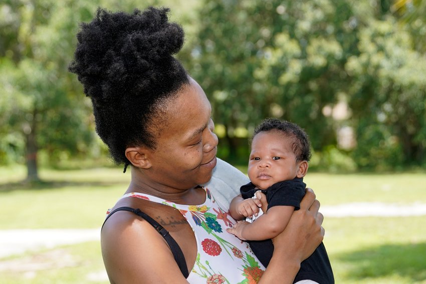 Venessa Aiken holds her son Jahzir Robinson, five weeks old, outside their home Sunday, Aug. 21, 2022, in Orlando, Fla. States around the country are making it easier for newborn moms to keep Medicaid in the year after childbirth, a crucial time when depression and other health problems can develop.