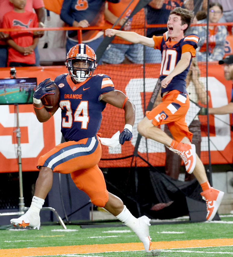 Syracuse running back Sean Tucker runs on the way to a touchdown against Louisville on Saturday night at the JMA Wireless Dome in Syracuse. Tucker rushed for 98 yards and scored two touchdowns, one on a 55-yard catch-and-run in the Orange's 31-7 win.