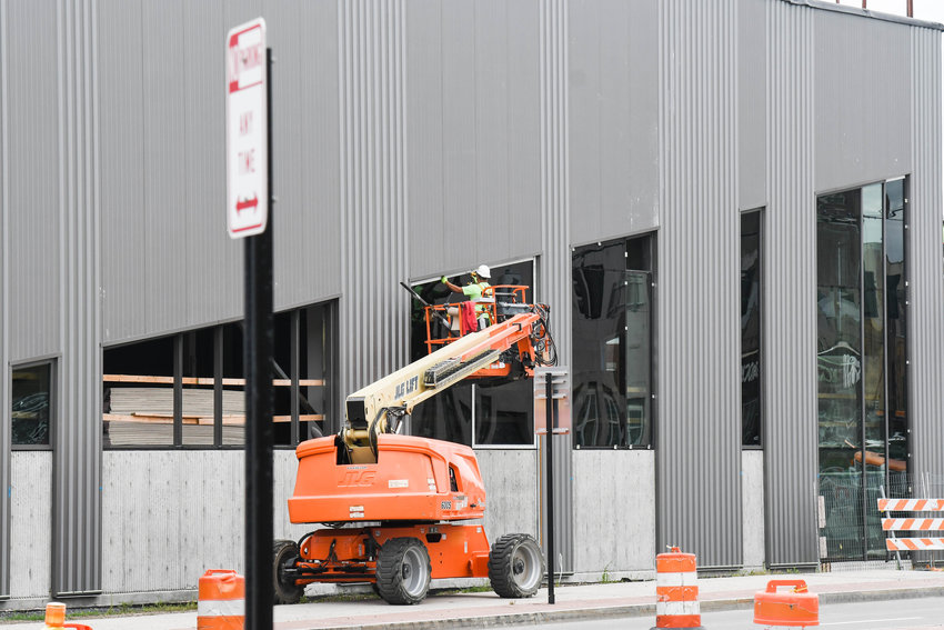 Glass is installed by a construction worker at the Nexus Center site in downtown Utica. The Upper Mohawk Valley Memorial Auditorium Authority is seeking a naming rights sponsor for the facility.